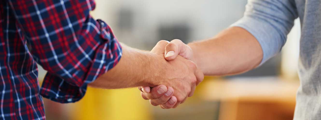 close up of two people shaking hands