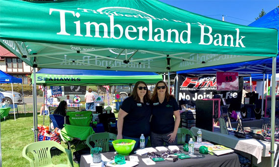 Employees pose for a photo at the Timberland Bank tent at the Edgewood Community Picnic