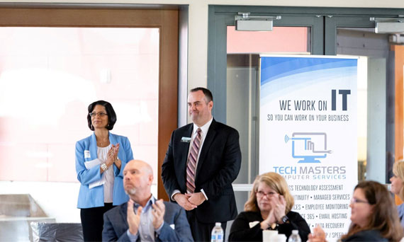 Timberland business banker and a colleague listen to a presentation.